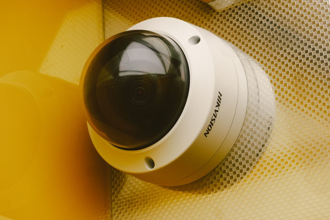 about-us Close-up of a modern security camera installed indoors, ideal for surveillance.
